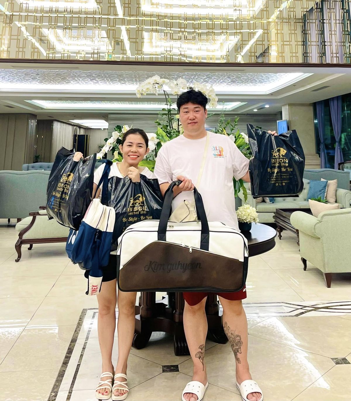Customer holding a custom monogrammed leather duffel bag from Bison Leather Shop